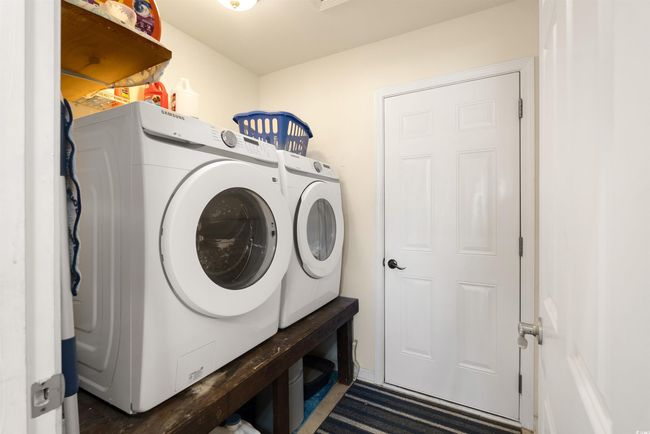 Laundry room featuring independent washer and dryer | Image 11