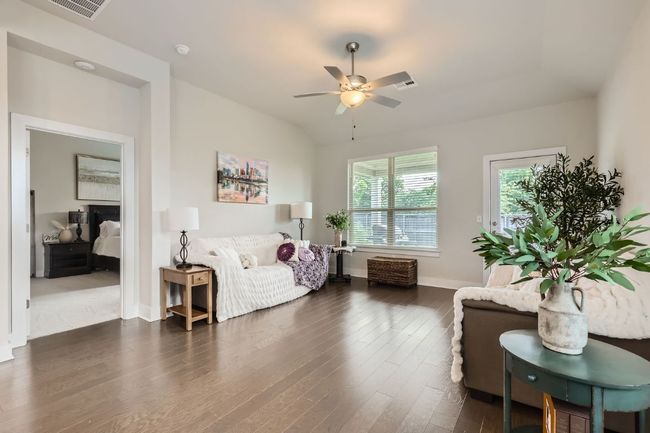 Living room featuring dark wood-style floors, a ceiling fan, and vaulted ceiling | Image 5