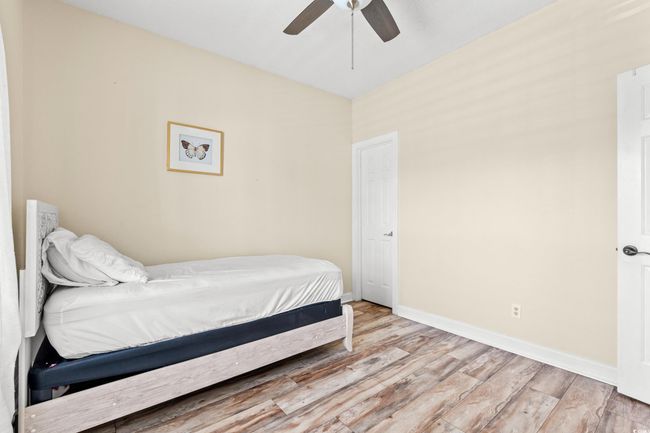 Bedroom featuring baseboards, light wood-style floors, and ceiling fan | Image 19