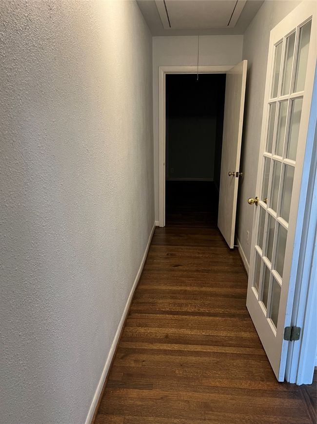 Corridor with dark wood-type flooring, attic access, and a textured wall | Image 21
