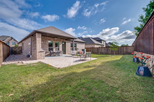 Large backyard with covered patio. | Image 8