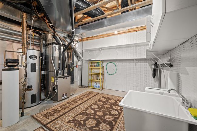 Spacious utility room with separate section full of shelves to keep everything organized. | Image 22
