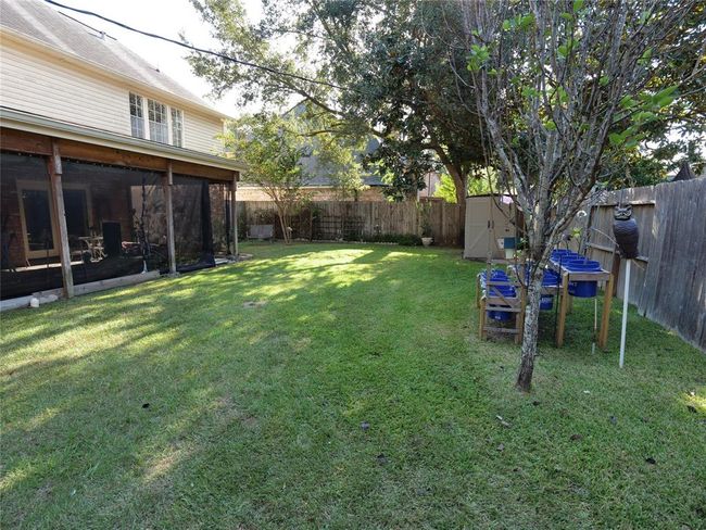 Storage building and vegetable garden in the backyard | Image 31