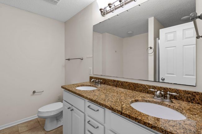 The private primary bath has a double sink vanity with lots of storage. | Image 25