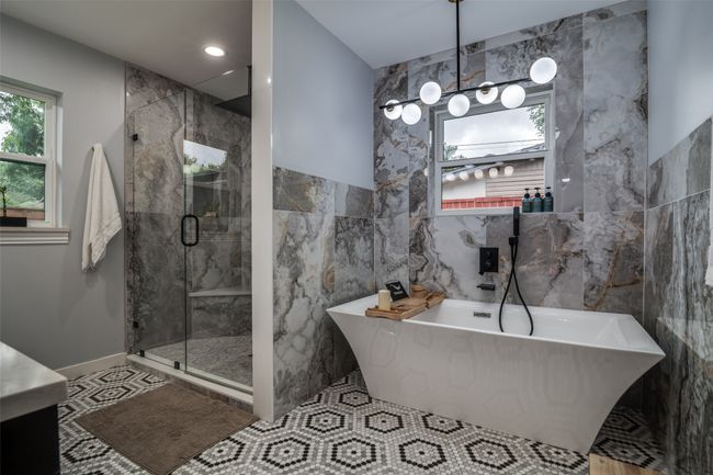 Bathroom with tile walls, plenty of natural light, a freestanding bath, and a shower stall | Image 20