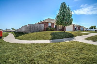 Ranch-style house with a front lawn and a garage | Image 2