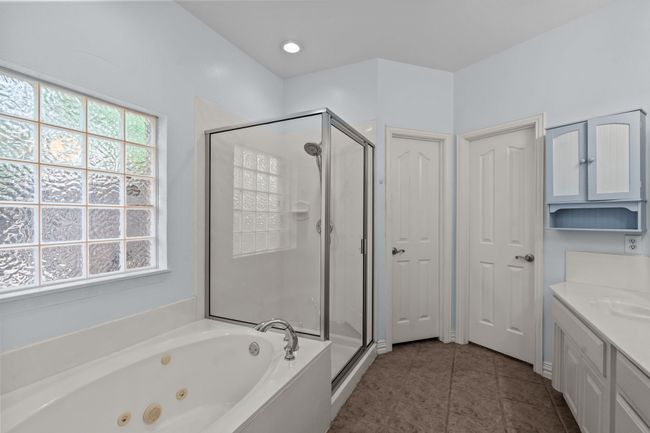 Primary bathroom with double vanity, tub and shower | Image 19