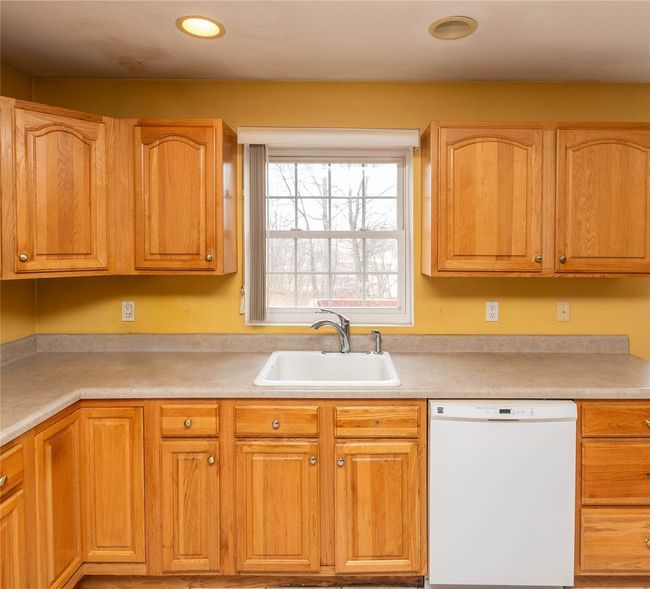 Kitchen featuring light countertops, white dishwasher, and a sink | Image 20