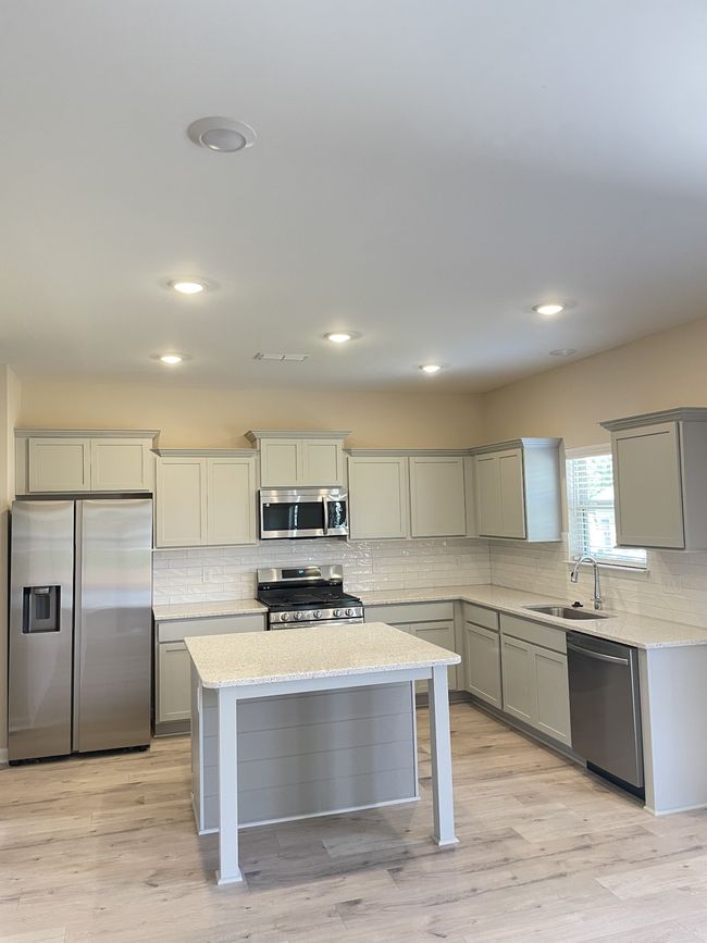 Shaker style staggered cabinets and luxury quartz countertops | Image 6