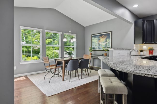 The vaulted dining area overlooks the serenity of this special backyard. I told you there is more green. Nature sings in all of the windows. | Image 11