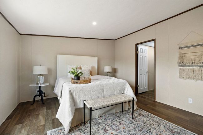 Bedroom with wood finished floors, recessed lighting, and crown molding | Image 23