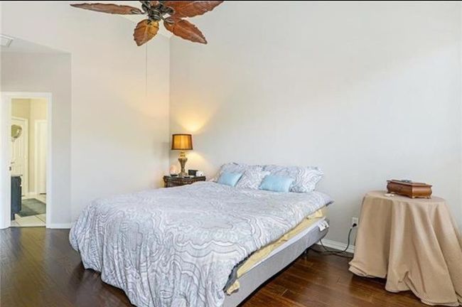 Bedroom with dark hardwood / wood-style flooring and ceiling fan | Image 19