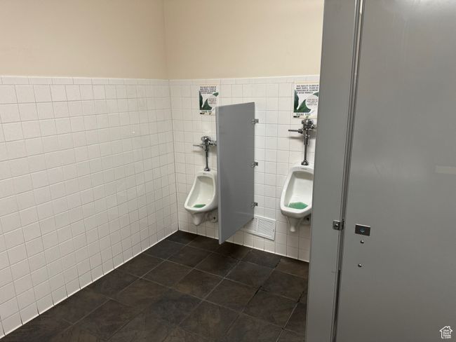 Bathroom with tile patterned flooring, visible vents, and tile walls | Image 11