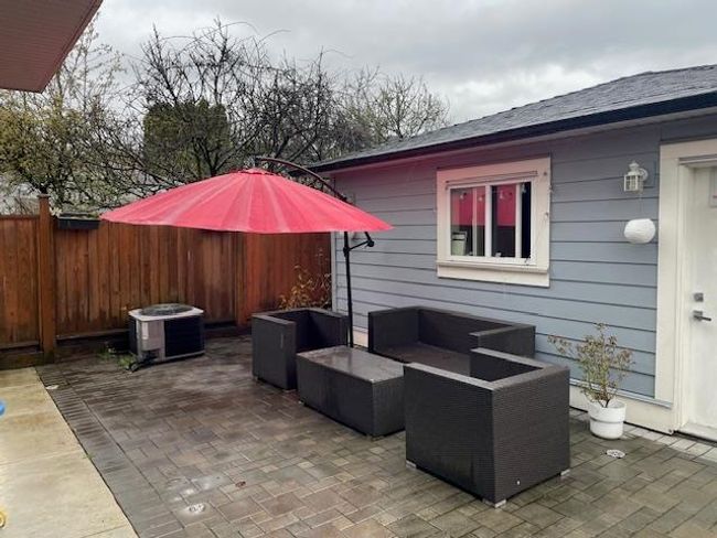 View of patio / terrace featuring fence, an outdoor hangout area, and central AC unit | Image 16