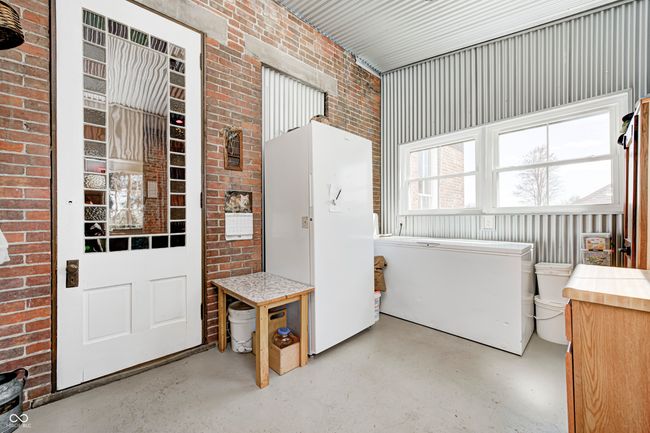 laundry room featuring metal wall and brick wall | Image 33