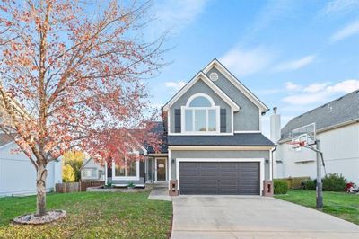 View of front of property with a front yard and a garage | Image 1