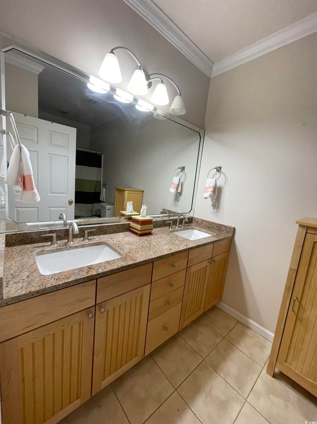 Full bath with double vanity, Crown Molding, and Tiled Flooring. Oversized Garden Soaking Tub insert with Shower Combo. | Image 18