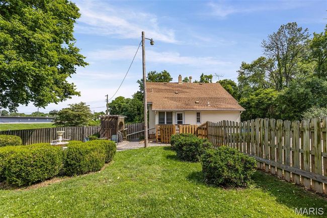Back of property featuring a fenced backyard and a chimney | Image 10