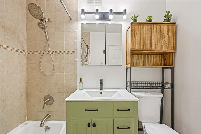 Bathroom with vanity, shower / tub combo, and toilet | Image 16