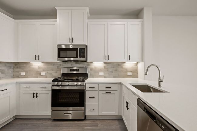 Featuring fantastic storage and prep space, this dream kitchen is finished in a classic color palette that will always be in style! | Image 8