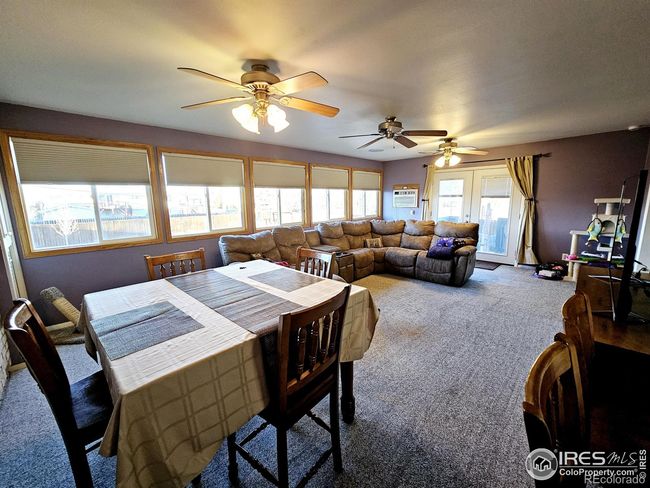 Great room with french doors leading to a deck which leads to the expansive backyard | Image 11