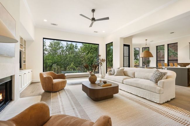 This expansive living room offers the perfect setting for both relaxed evenings and lively entertaining, with abundant natural light pouring in through large windows. | Image 4