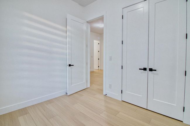 Unfurnished bedroom featuring light wood-type flooring and baseboards | Image 24