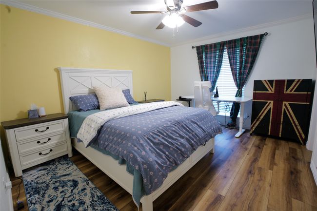 Bedroom featuring crown molding, dark wood-type flooring, and ceiling fan | Image 22