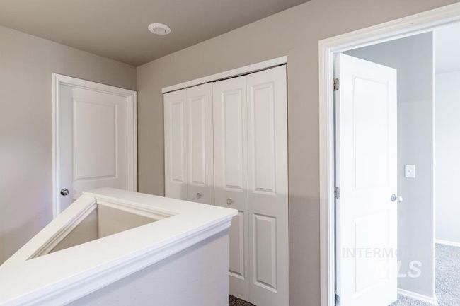 Hallway with carpet and baseboards | Image 17