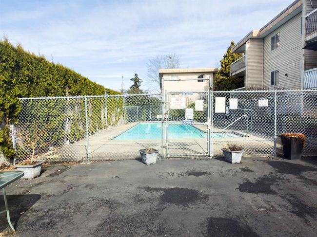 Community pool with a gate and fence | Image 16