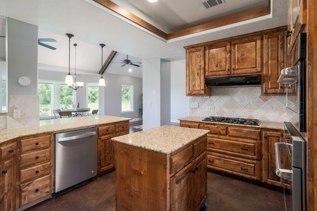 Ample cabinets and countertops including rolling island. | Image 12
