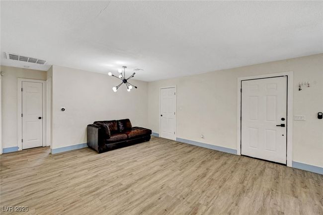 Unfurnished room featuring light wood-style flooring and a chandelier | Image 7