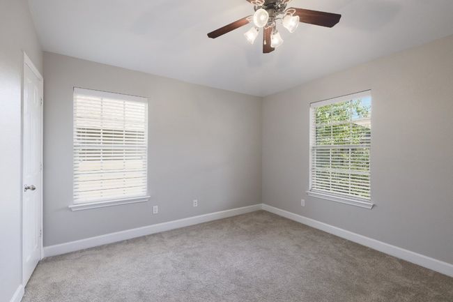 Second bedroom with carpet flooring, and ceiling fan | Image 14