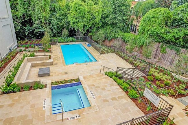 [Pool and Spa] Backyard oasis with inviting wave pool and relaxing spa, complemented by a serene lounge area and vibrant landscaping. The perfect staycation retreat awaits! | Image 4