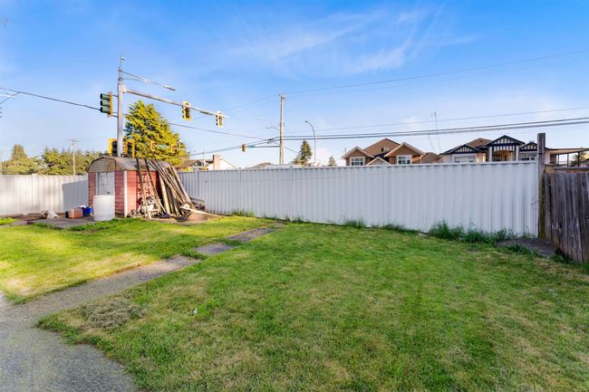 View of yard with a fenced backyard, a storage unit, and an outbuilding | Image 21
