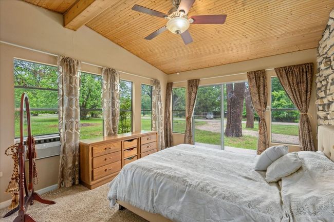 Carpeted bedroom featuring wood ceiling and a ceiling fan | Image 15