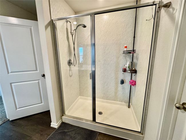 Full bath with a stall shower and wood finished floors | Image 9