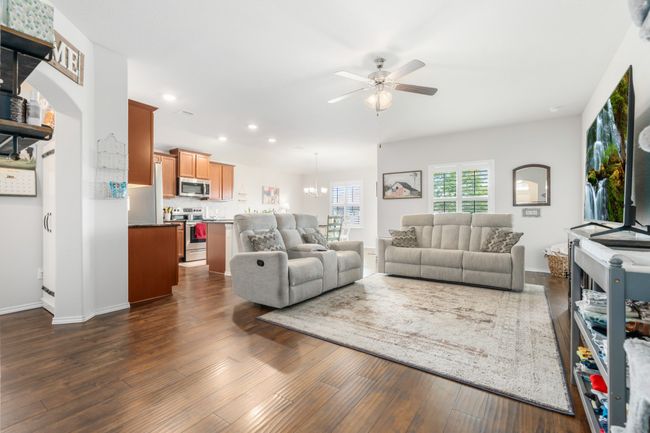 Living area with ceiling fan, dark wood-style floors, recessed lighting, and baseboards | Image 13