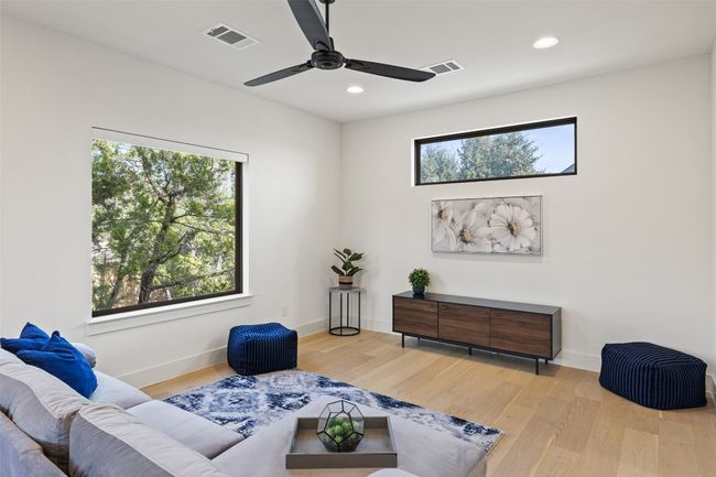 Living room with recessed lighting, visible vents, baseboards, and wood finished floors | Image 26
