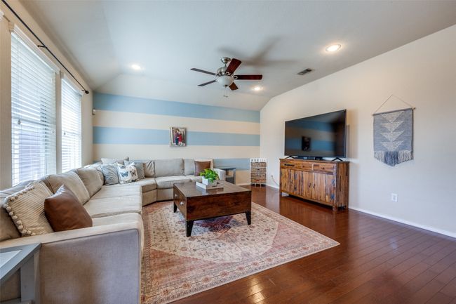 Living room featuring ceiling fan, dark wood finished floors, recessed lighting, and lofted ceiling | Image 10