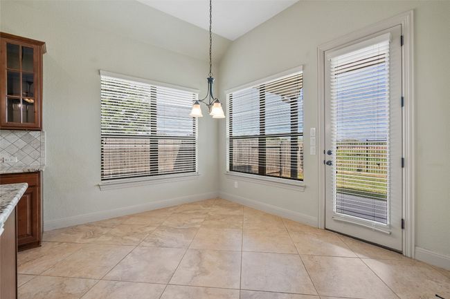 Unfurnished dining area featuring healthy amount of natural light and light tile patterned flooring | Image 24