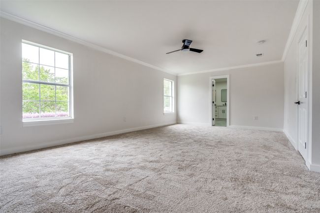 Unfurnished room featuring crown molding, carpet, and a ceiling fan | Image 18