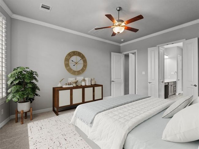 Primary bedroom located on the first floor features plantation shutters, crown molding and a private en-suite bath | Image 19