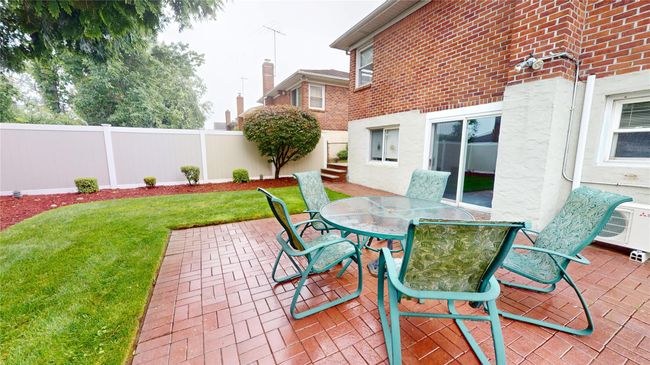 Fenced backyard featuring a patio area and outdoor dining area | Image 21