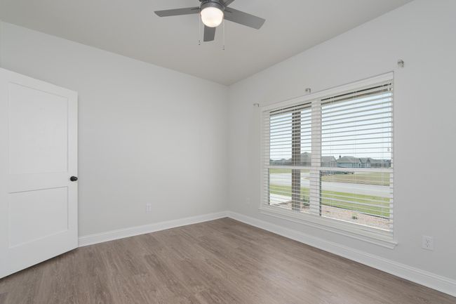 Empty room with baseboards, a ceiling fan, and wood finished floors | Image 26