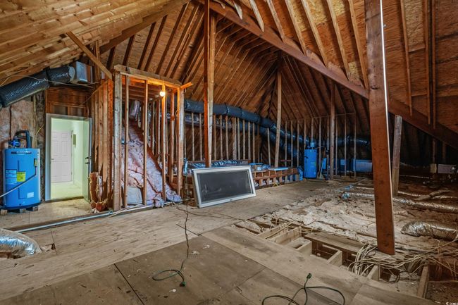 Unfinished attic with water heater and gas water heater | Image 36