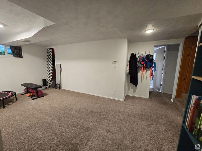 Finished basement featuring baseboards, visible vents, and carpet floors | Image 31