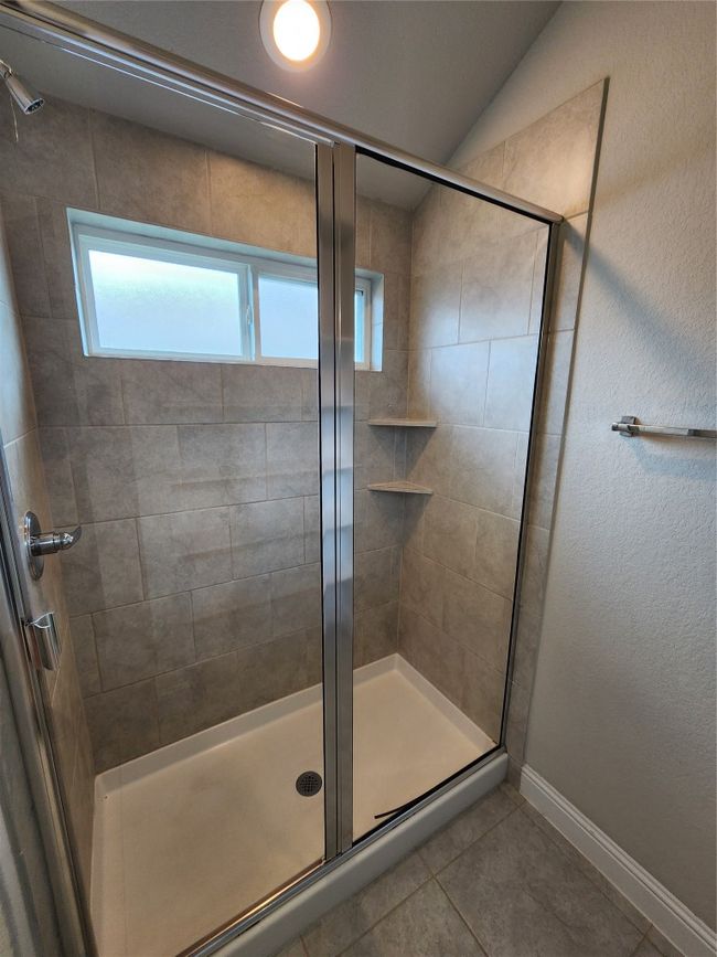 Bathroom with tile patterned flooring and a shower stall | Image 14