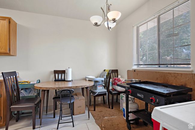 Dining room with a chandelier | Image 11