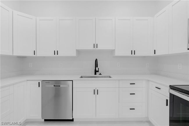 Kitchen featuring appliances with stainless steel finishes, white cabinetry, and sink | Image 33